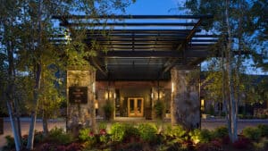 The hotel entrance of The Allison Inn & Spa light up at night.