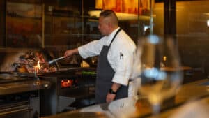 Executive Chef Jack Strong cooking over live fire in the kitchen.