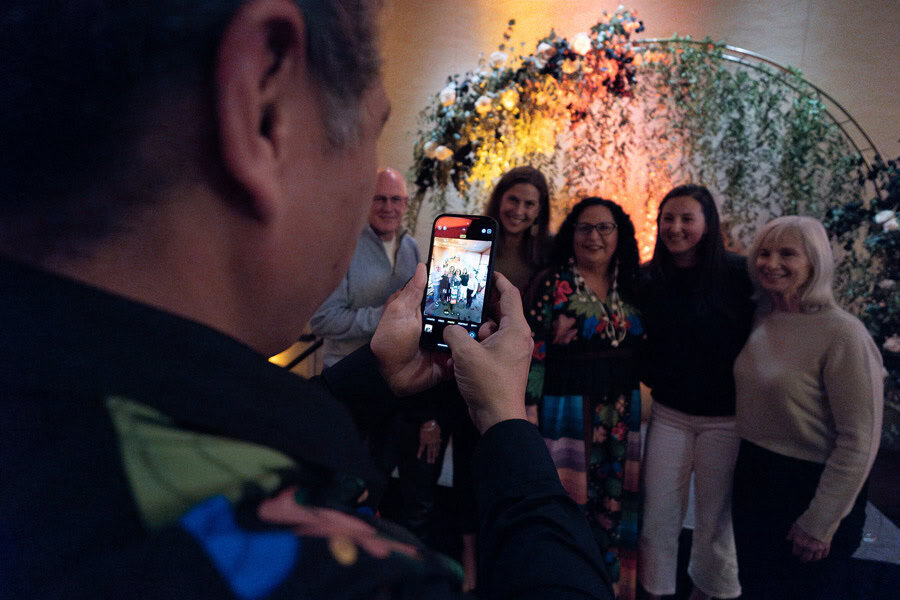 Five guests at the NAHM celebration having their photo taken during the dinner reception.