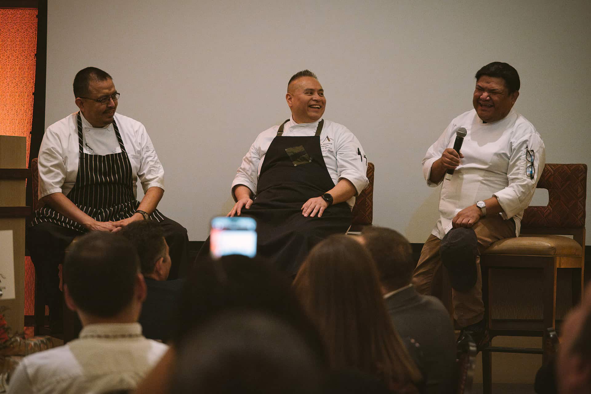 Chefs Nephi Craig, Jack Strong and Freddie Bitsoie sitting on the stage for a Q&A session at the 2024 Celebration of First Foods Dinner.