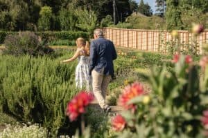 Two guests walking through the Chef's Garden on a summer evening