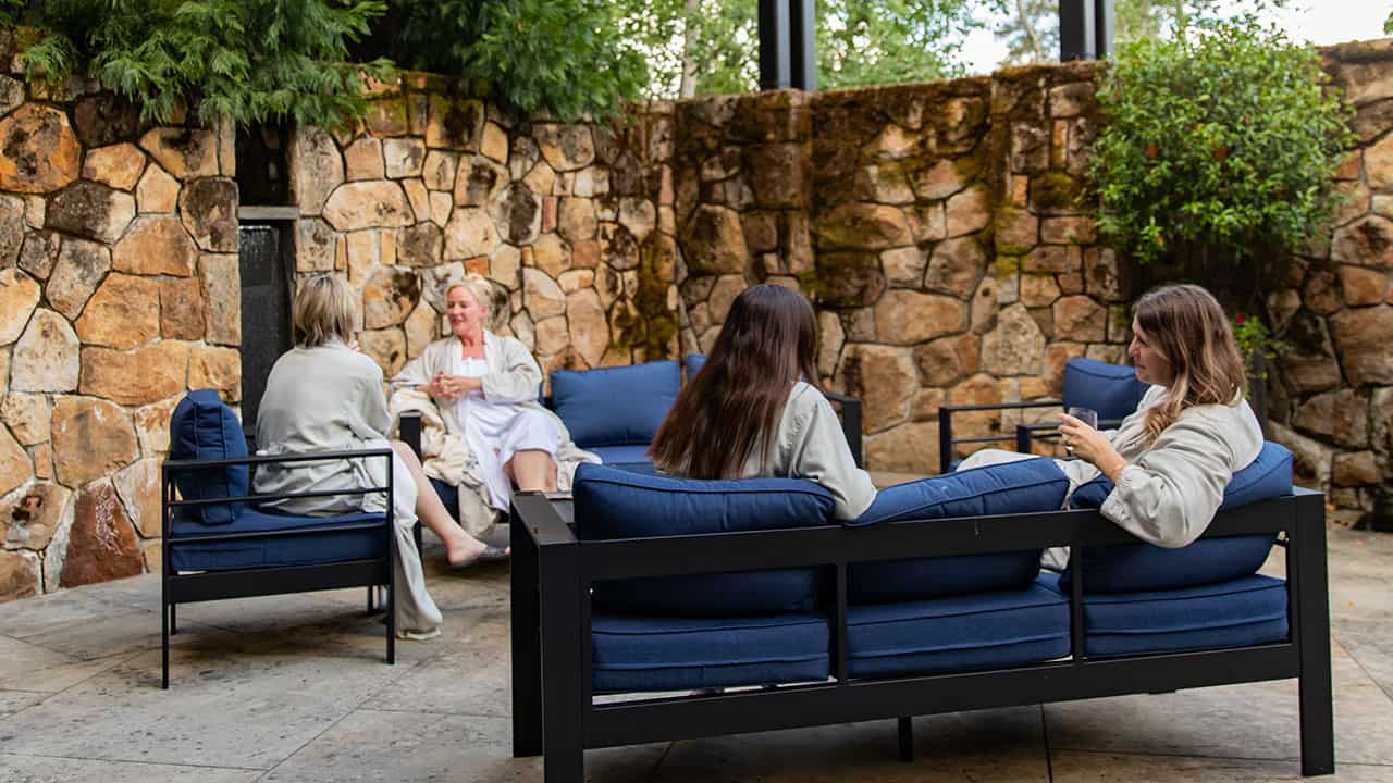 Four guests in robes on the spa terrace.