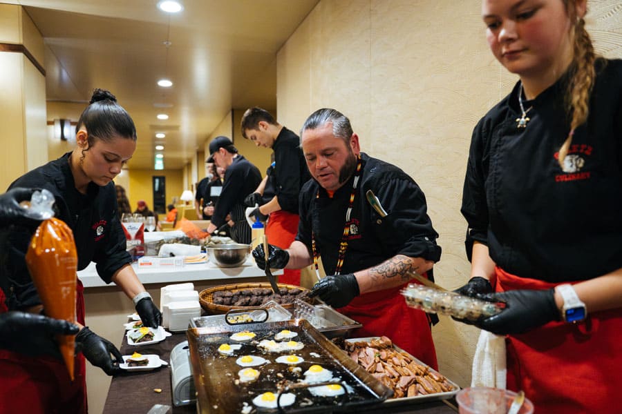 Culinary Director Patrick Clarke with his Siletz Valley students preparing hors d'oeuvres during the 2025 dinner reception.