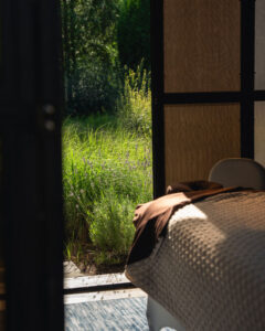 A view of the Zen Den treatment table looking out, surrounded by lavender.
