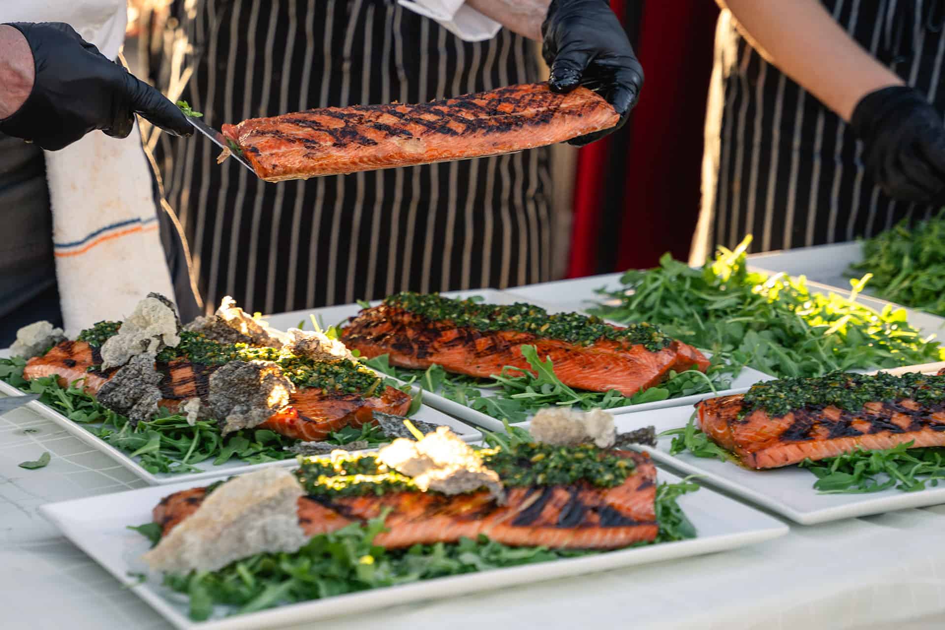 The culinary team grilling salmon in the Chef's Garden.