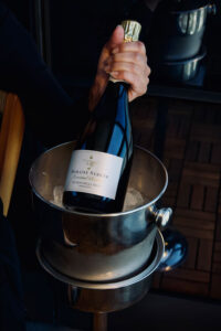 Bottle of Domaine Serene sparkling wine chilling in a bucket.