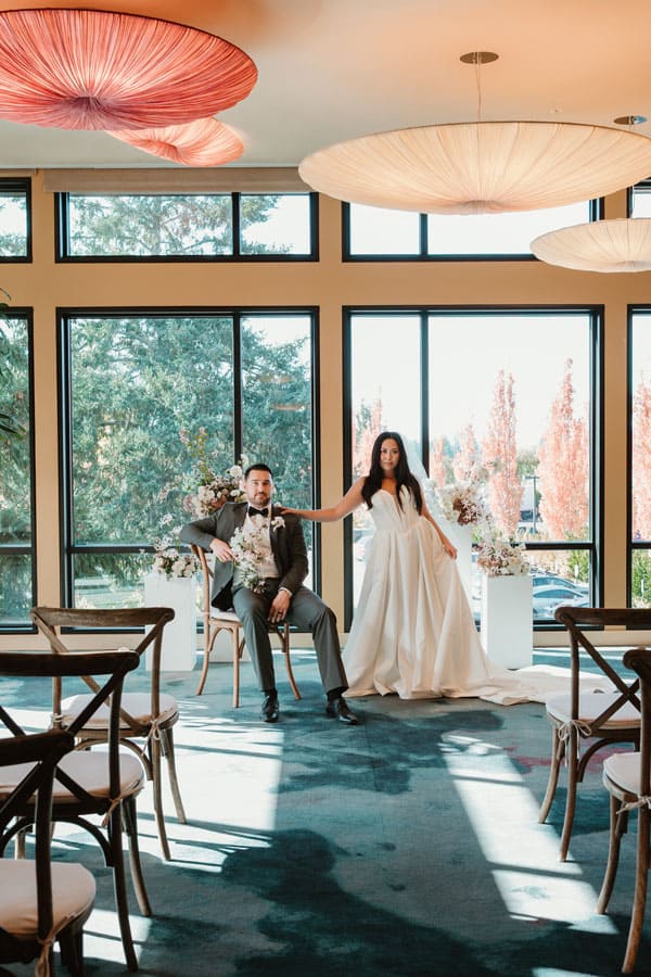 A bride and groom posing in the Grand Reception Foyer ahead of their wedding ceremony.