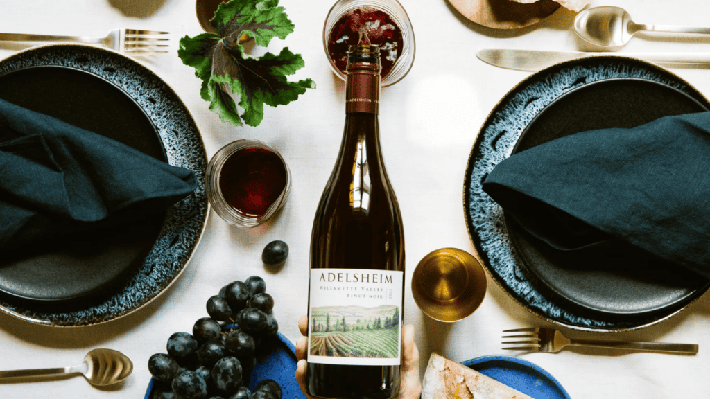 A bottle of wine from Adelsheim Vineyard being poured.