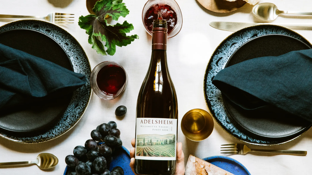 A bottle of wine from Adelsheim Vineyard being poured.
