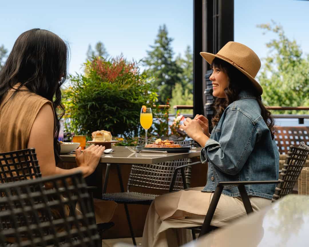 Two female guests dining on the living room terrace.