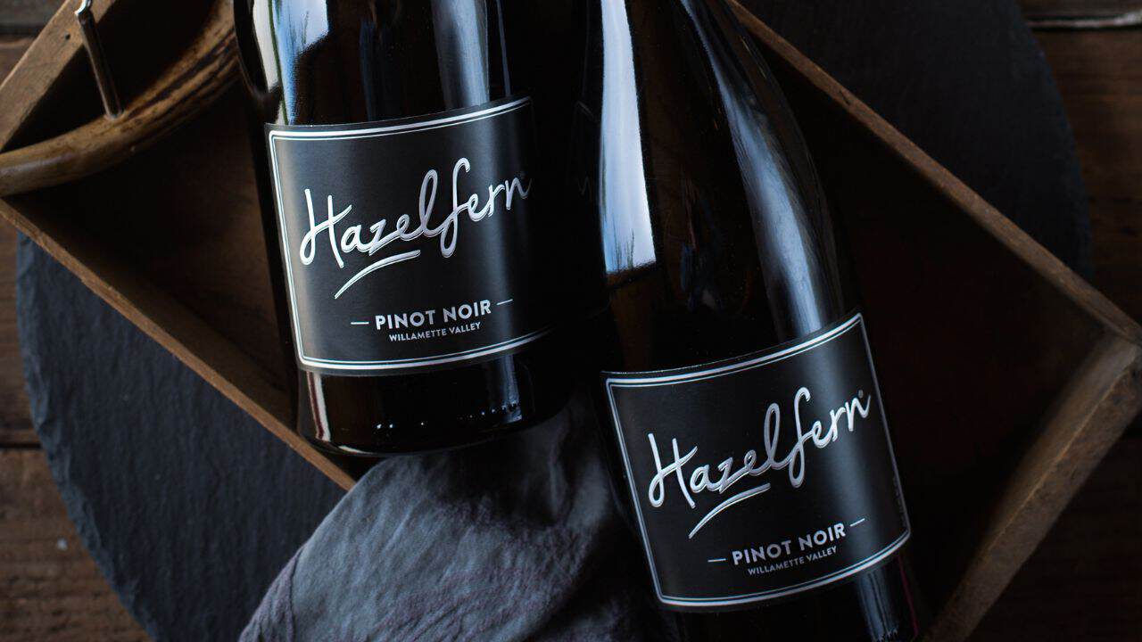 Bottles of Hazelfern Cellars' wine in a wood basket.