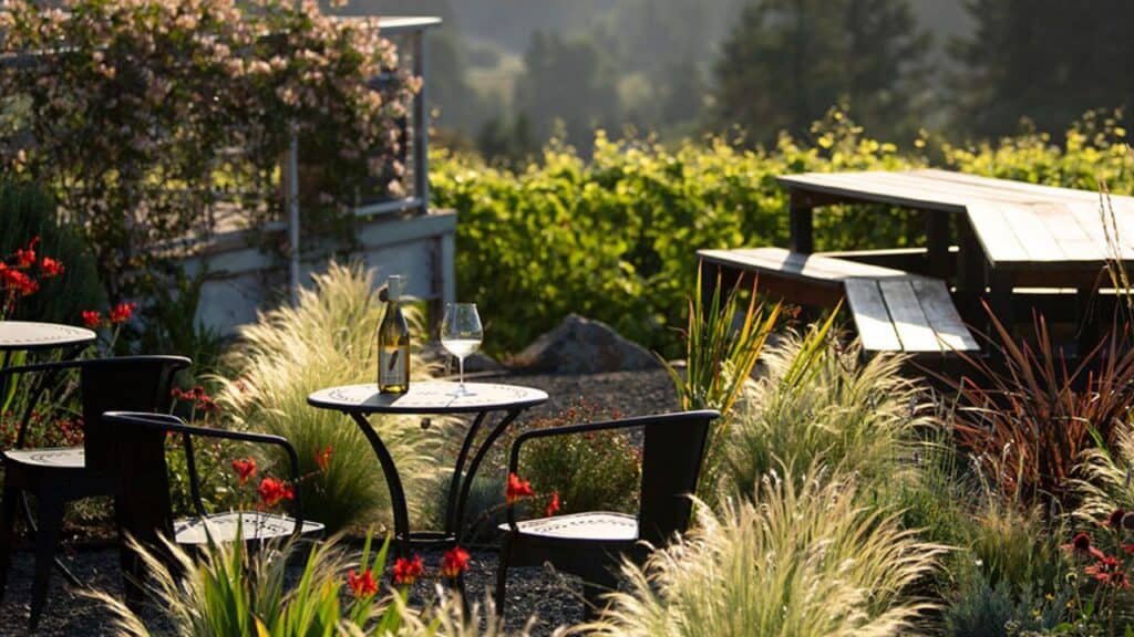A bottle of Raptor Ridge Vineyards wine on the patio of their tasting room.