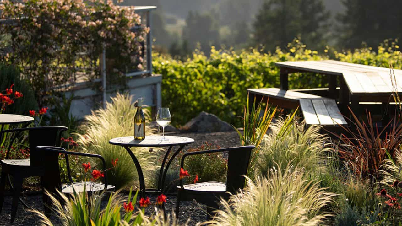 A bottle of Raptor Ridge Vineyards wine on the patio of their tasting room.