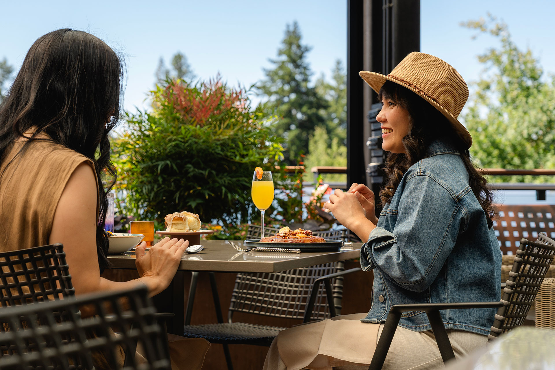 Two female guests dining on the living room terrace.