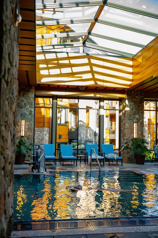 A guest floating weightlessly on their back in the pool.