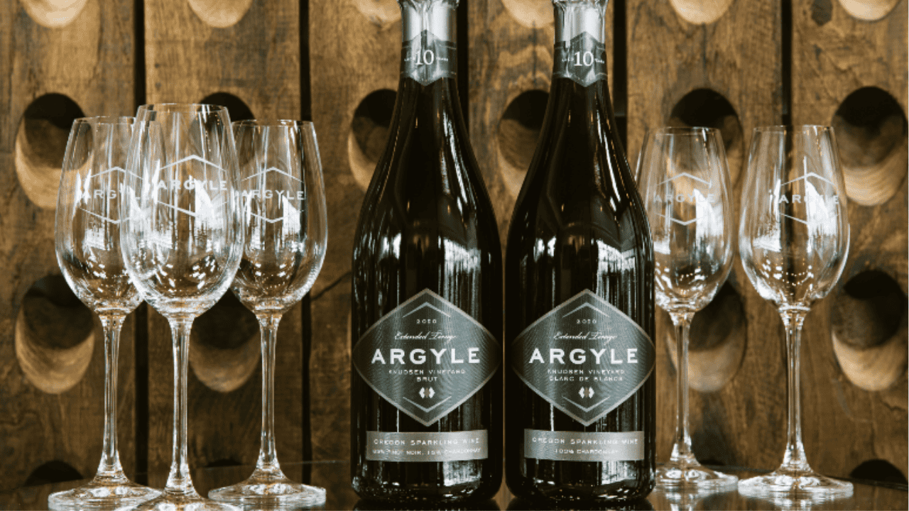 Two bottles of wine from Argyle Winery surrounded by wine glasses.