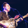 Musician Ben Rice singing with his guitar.