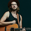 A portrait of Jacob Westfall with his guitar.