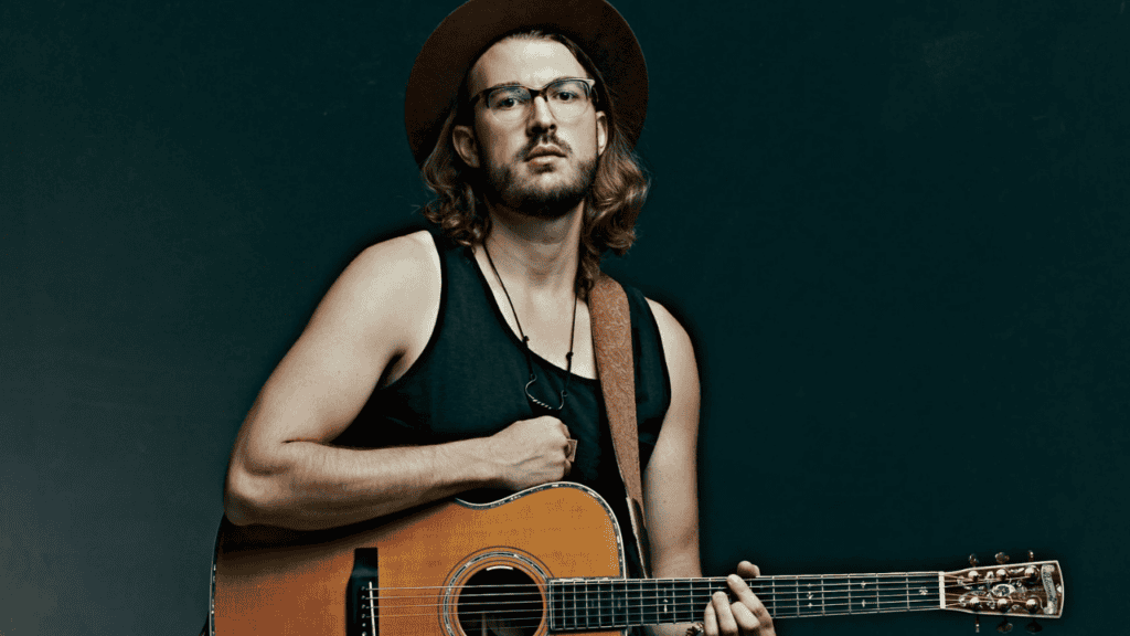 A portrait of Jacob Westfall with his guitar.