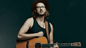 A portrait of Jacob Westfall with his guitar.