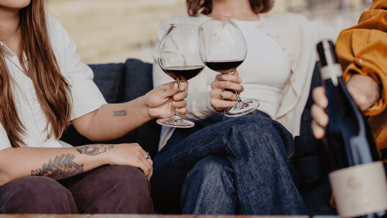 Two guests clinking their glasses with Soter Vineyards wine.