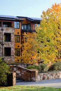The Allison Inn & Spa guest rooms hidden behind fall leaves. 
