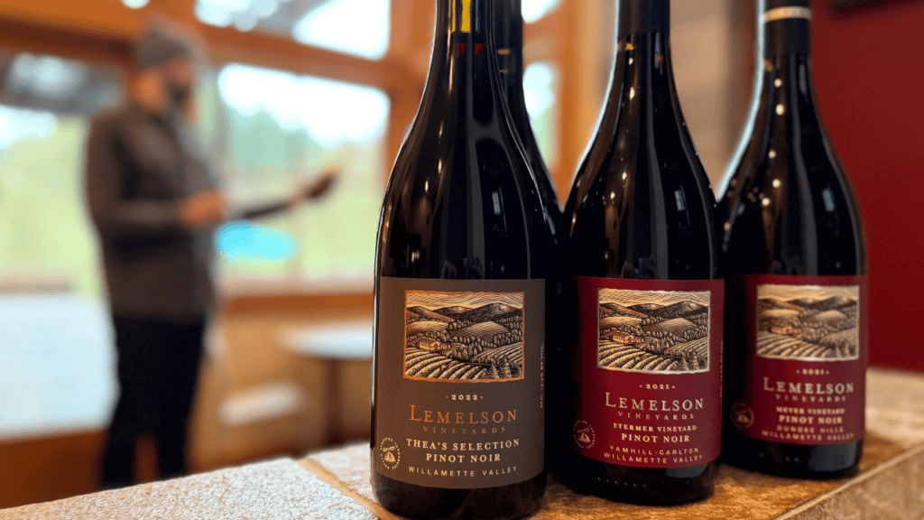 Three bottles of Lemelson Vineyard wine on a table.