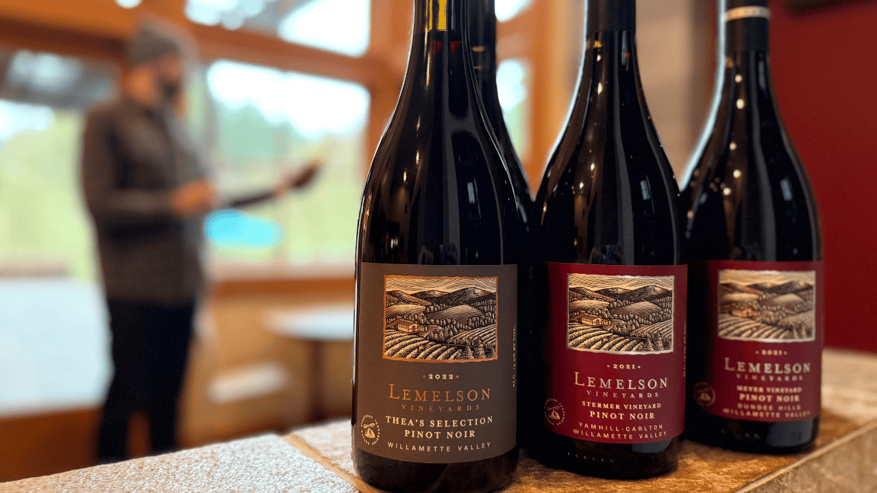 Three bottles of Lemelson Vineyard wine on a table.