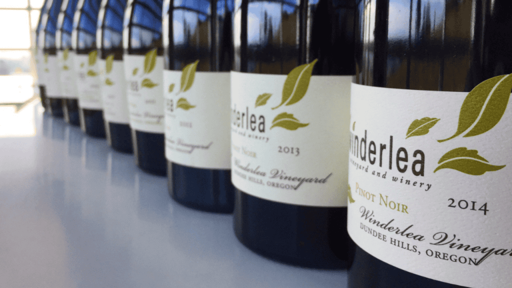 An up-close shot of the labels on Winderlea wine bottles.
