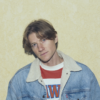 A photo of Lostboycrow, a musician performing in the living room.