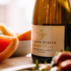 A close-up of Domaine Serene's wine with fruit.