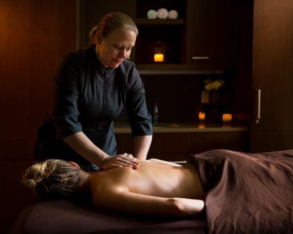 License Massage Therapist performing a massage on a female guest.